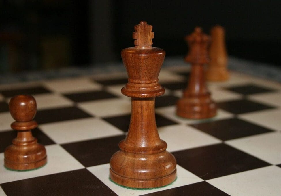 A close up of some chess pieces on the board